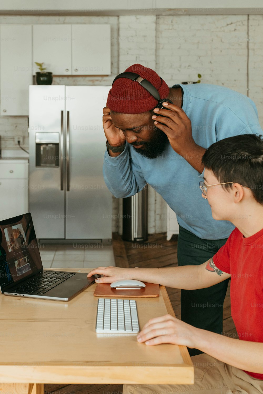 a man and a boy are looking at a laptop