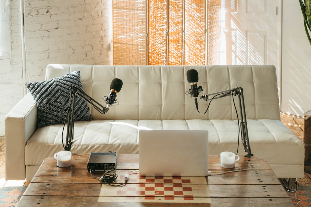 a couch with two microphones and a laptop on it