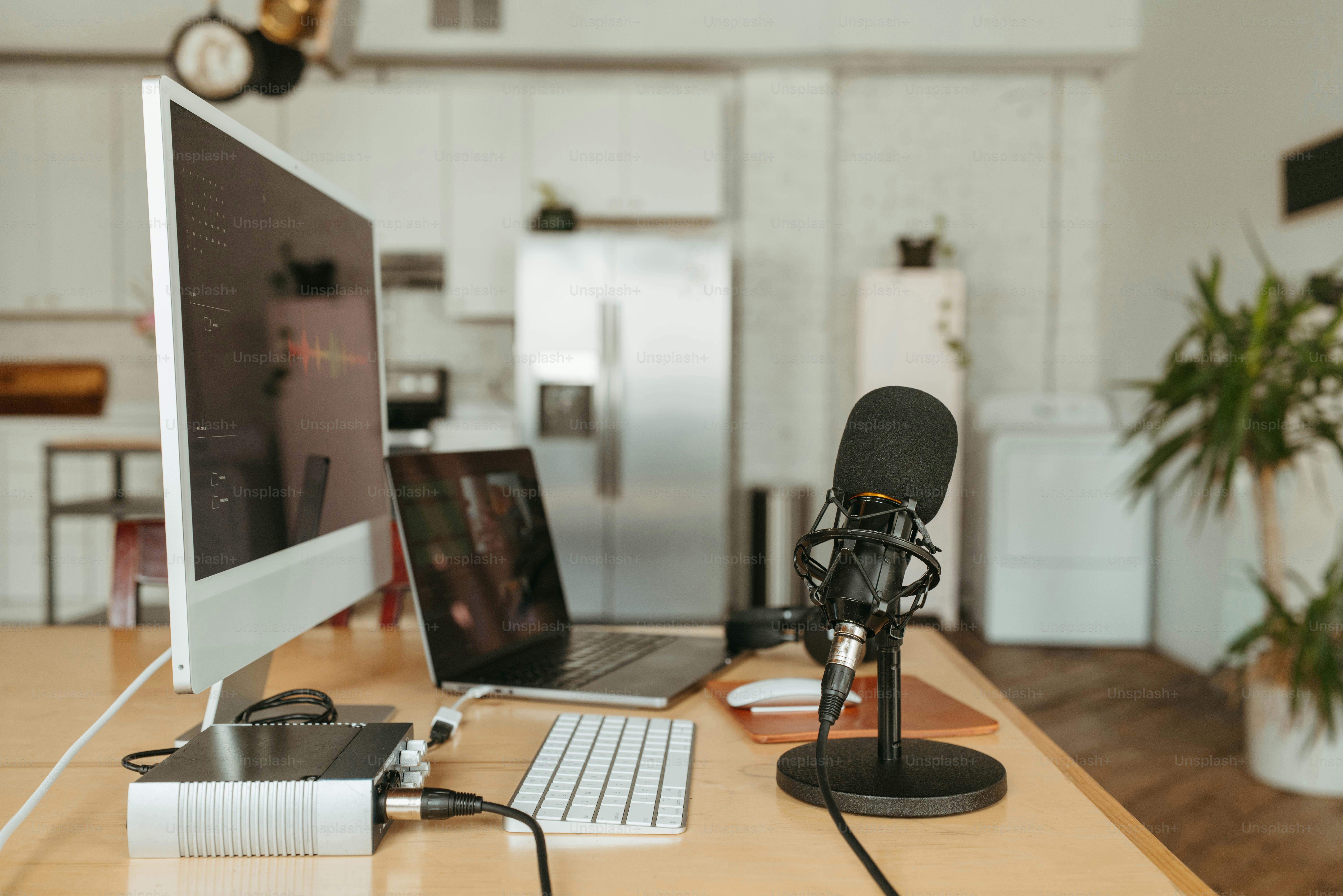 a desk with a computer and a microphone on it