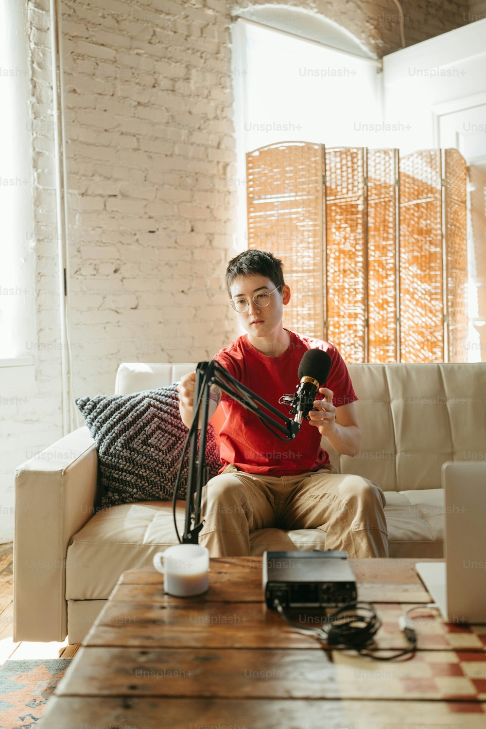 a man sitting on a couch holding a camera
