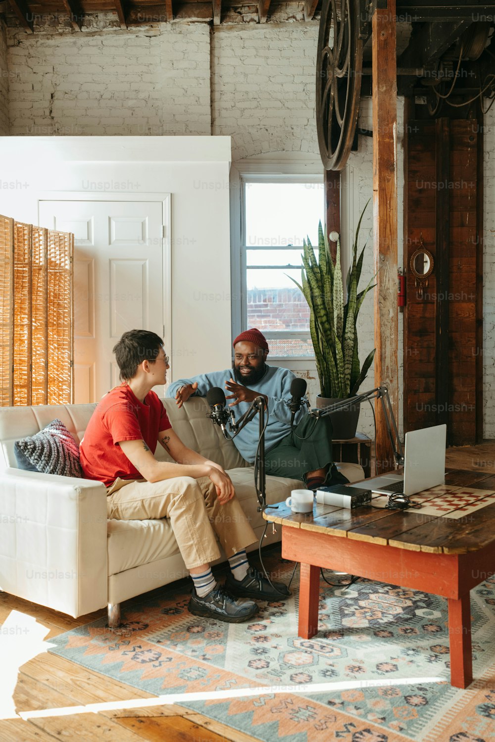 a man and a woman sitting on a couch in a living room
