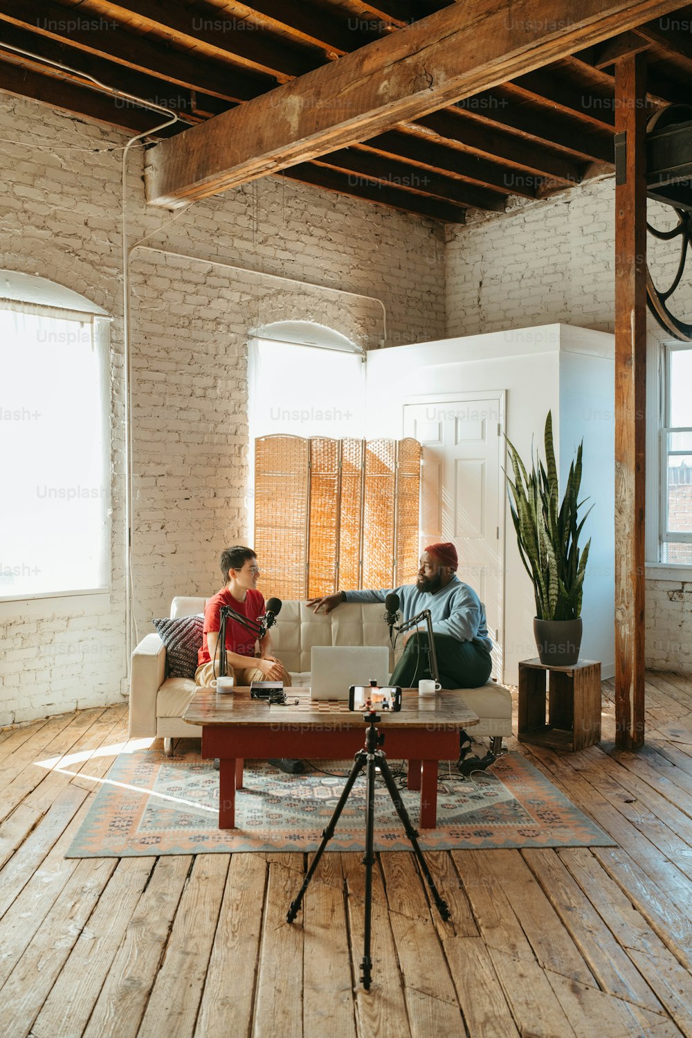 a couple of people sitting on a couch in a living room