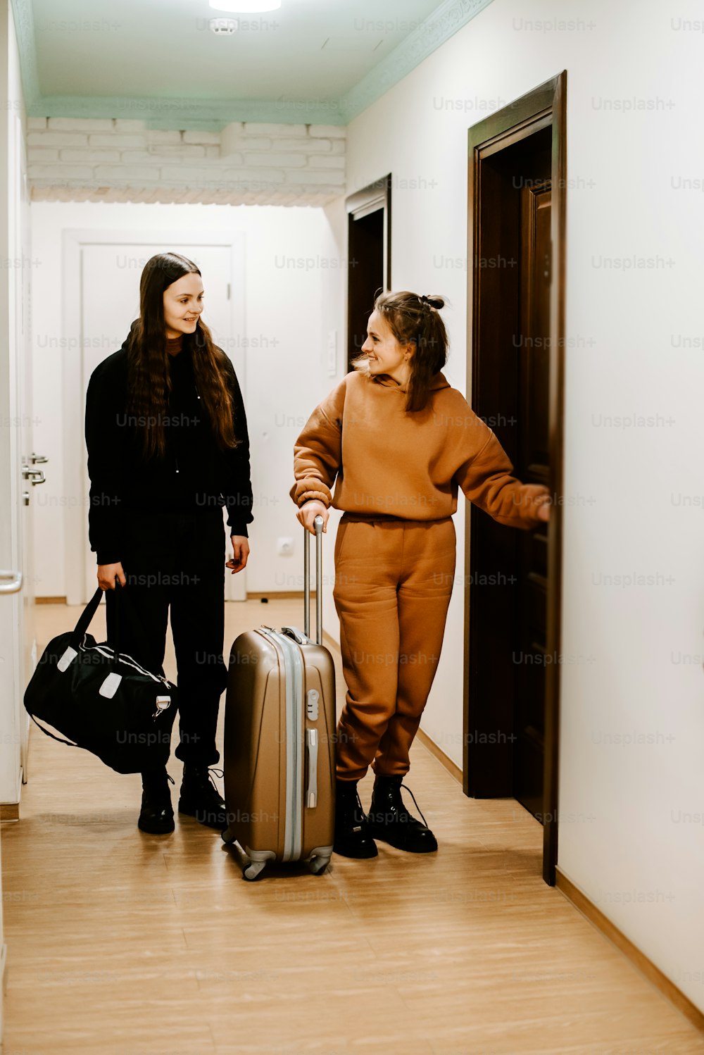 a couple of women standing next to each other with luggage