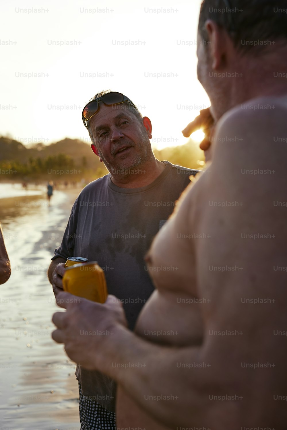 a group of men standing next to each other on a beach