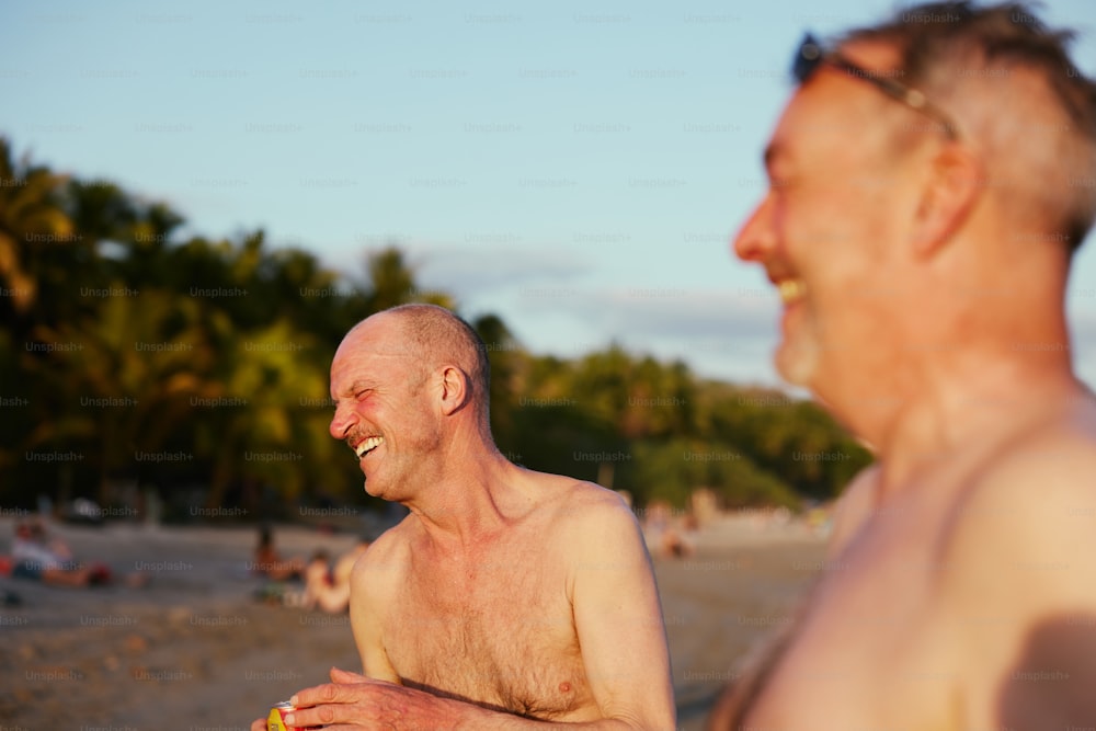 a man eating a slice of pizza on the beach