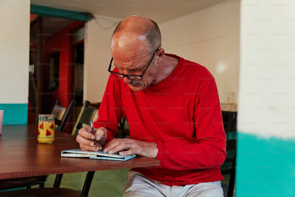 a man sitting at a table with a tablet