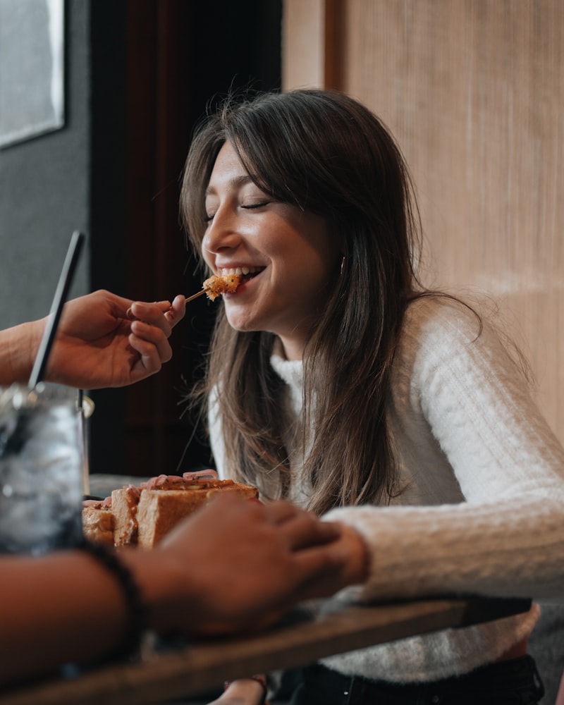 Woman sitting at table enjoying a meal