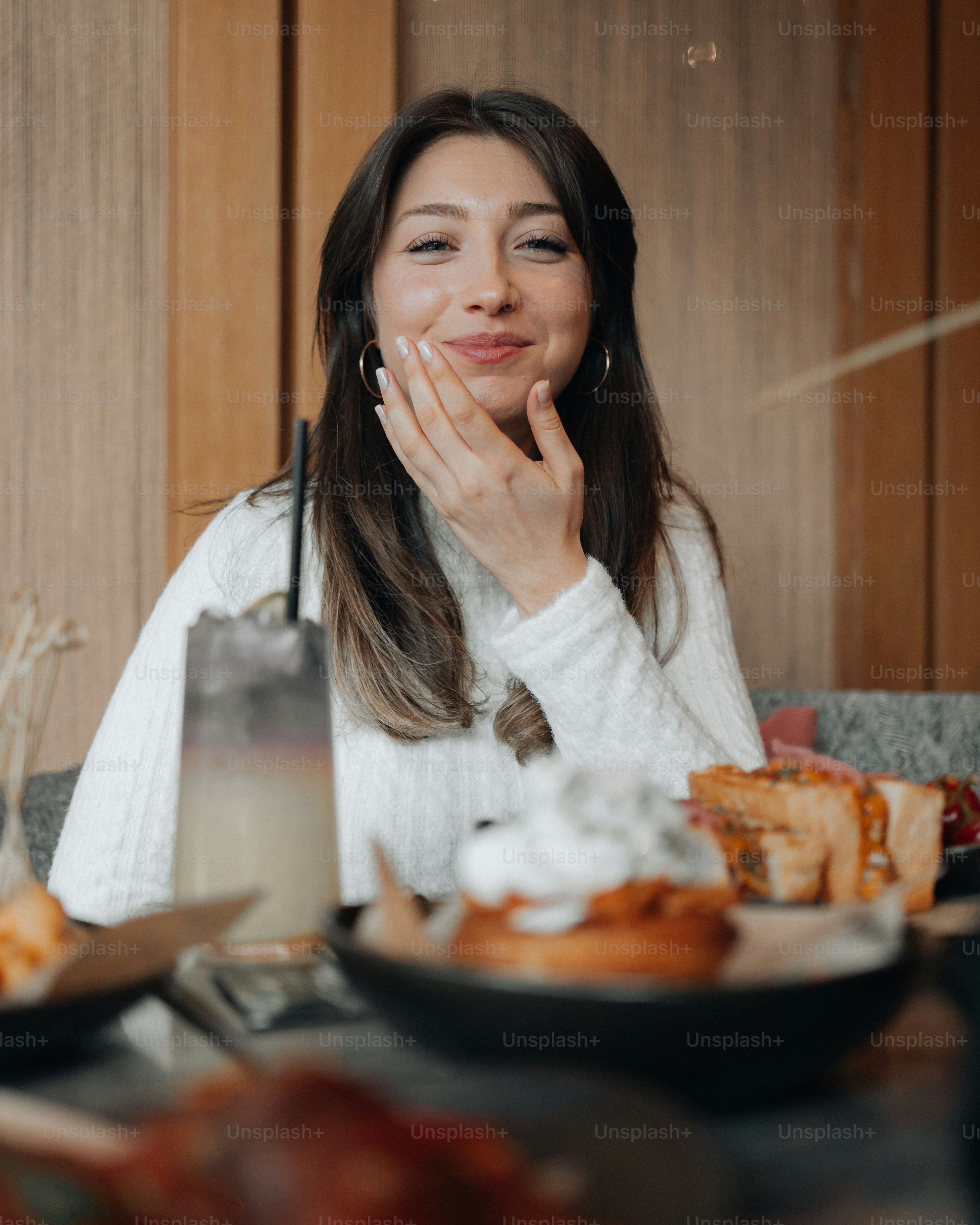 a woman sitting at a table with a plate of food