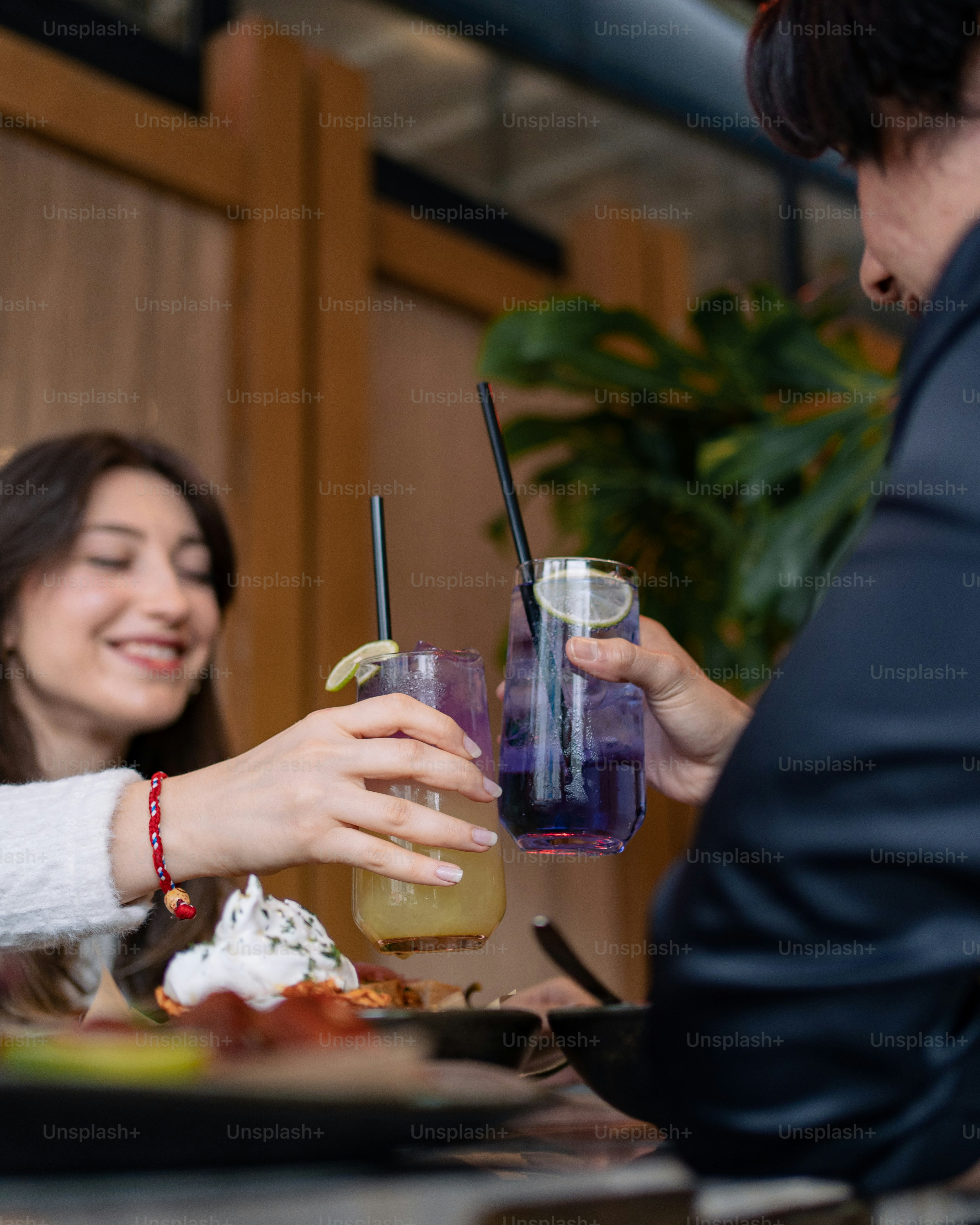 a man and a woman sitting at a table with drinks