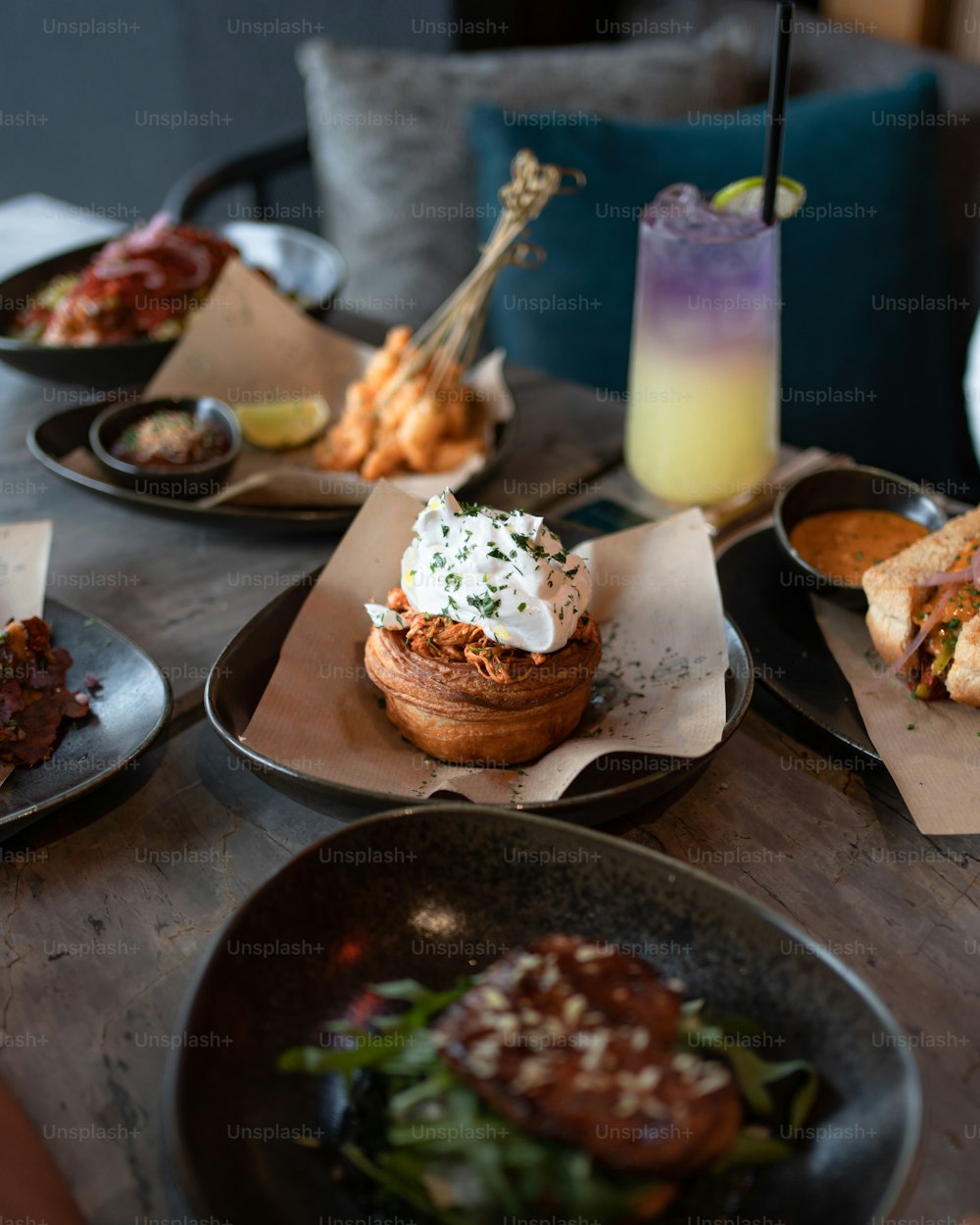 a wooden table topped with plates of food