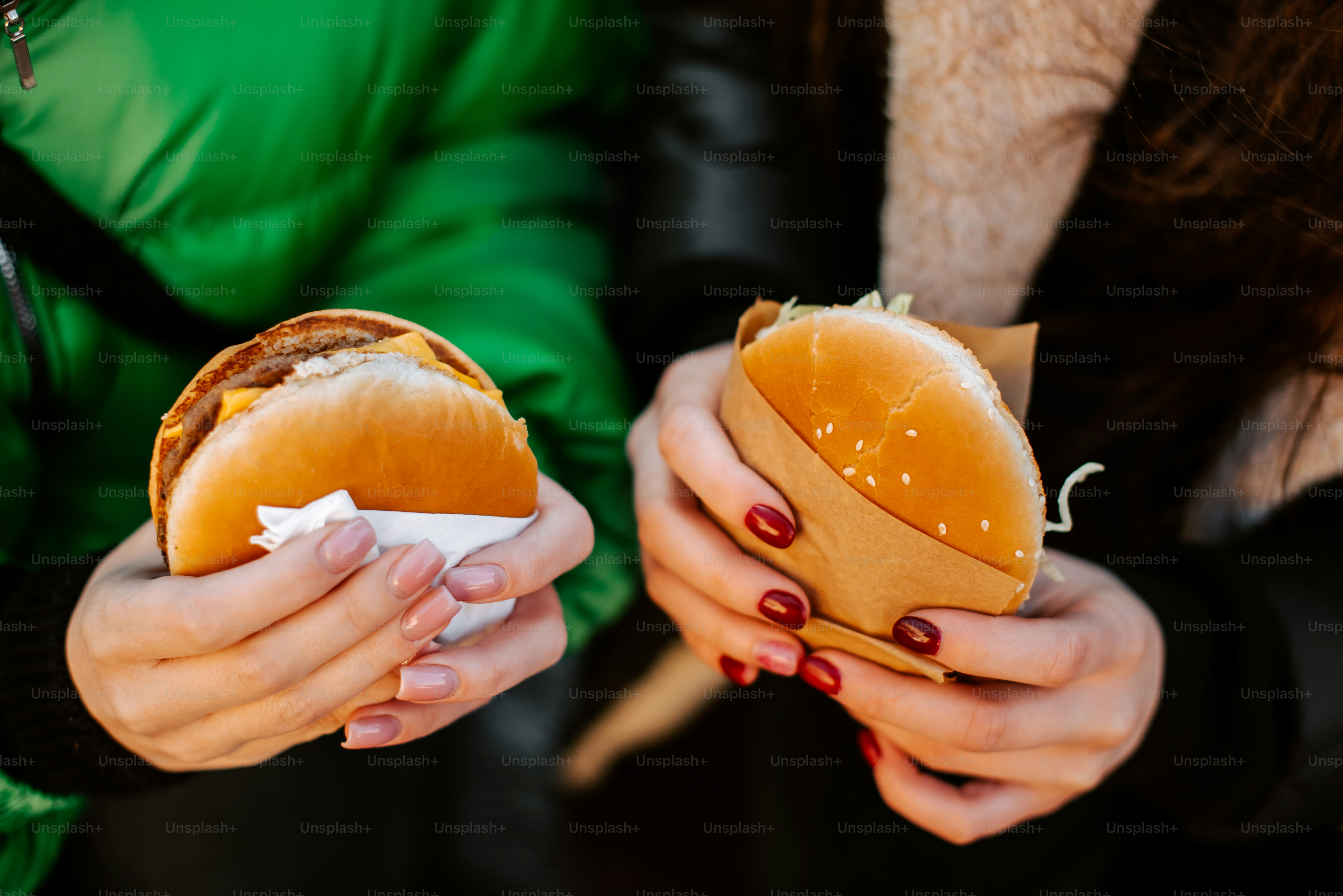 a woman holding a hot dog in her hands