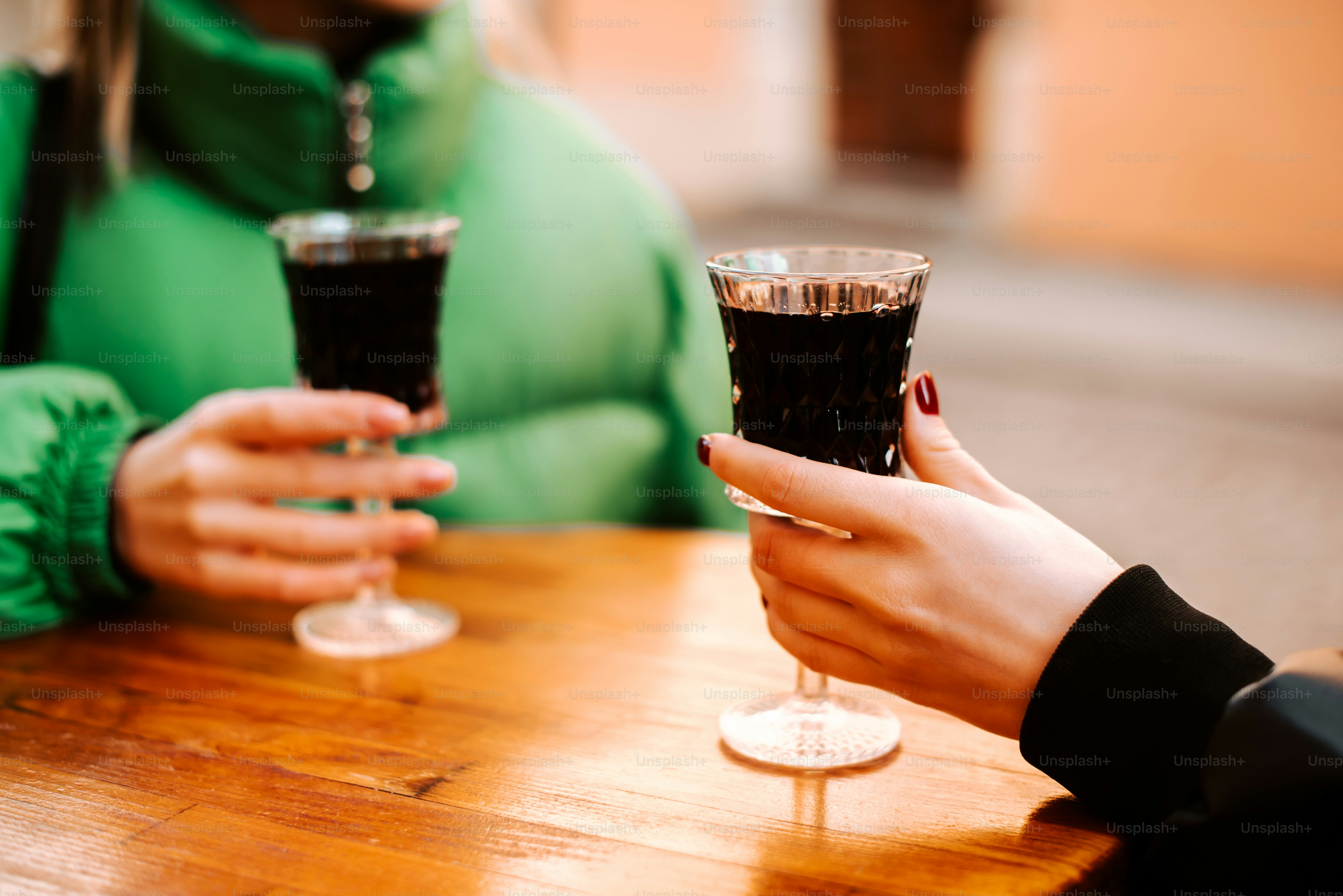 a couple of people sitting at a table holding wine glasses