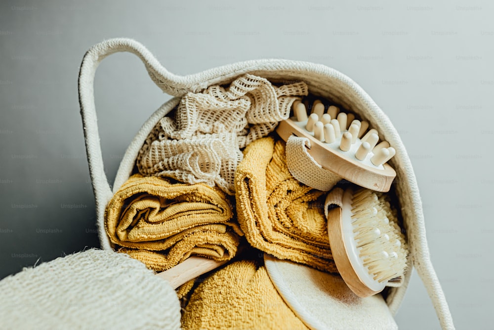 a white bag filled with yellow and white towels