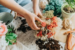 a person is arranging flowers on a table