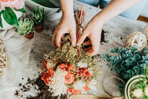 a person is arranging flowers on a table