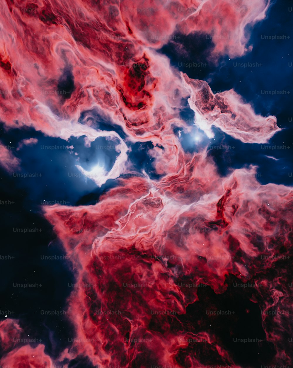 a red and blue space filled with stars and clouds
