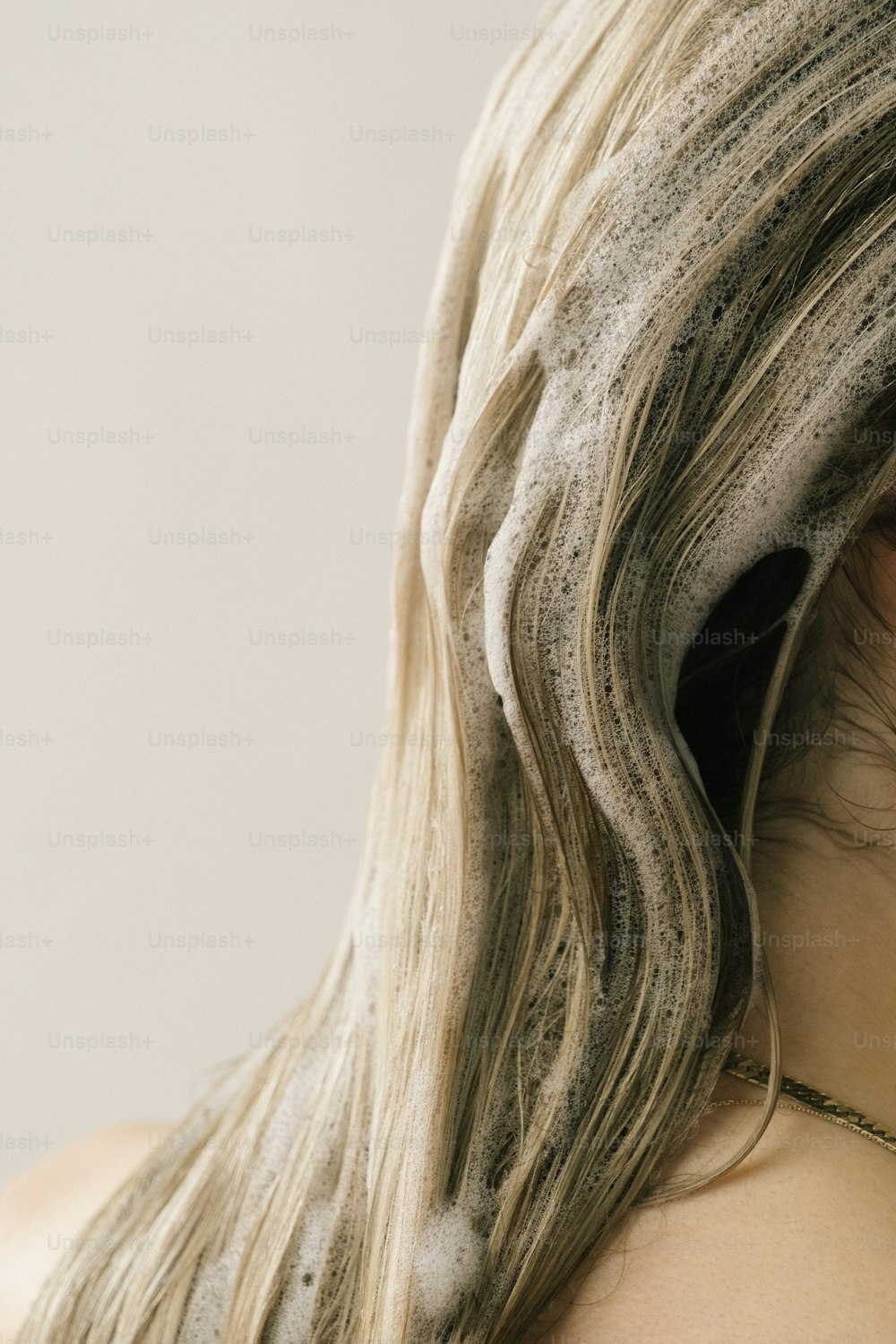 a close up of a woman's head with hair blowing in the wind