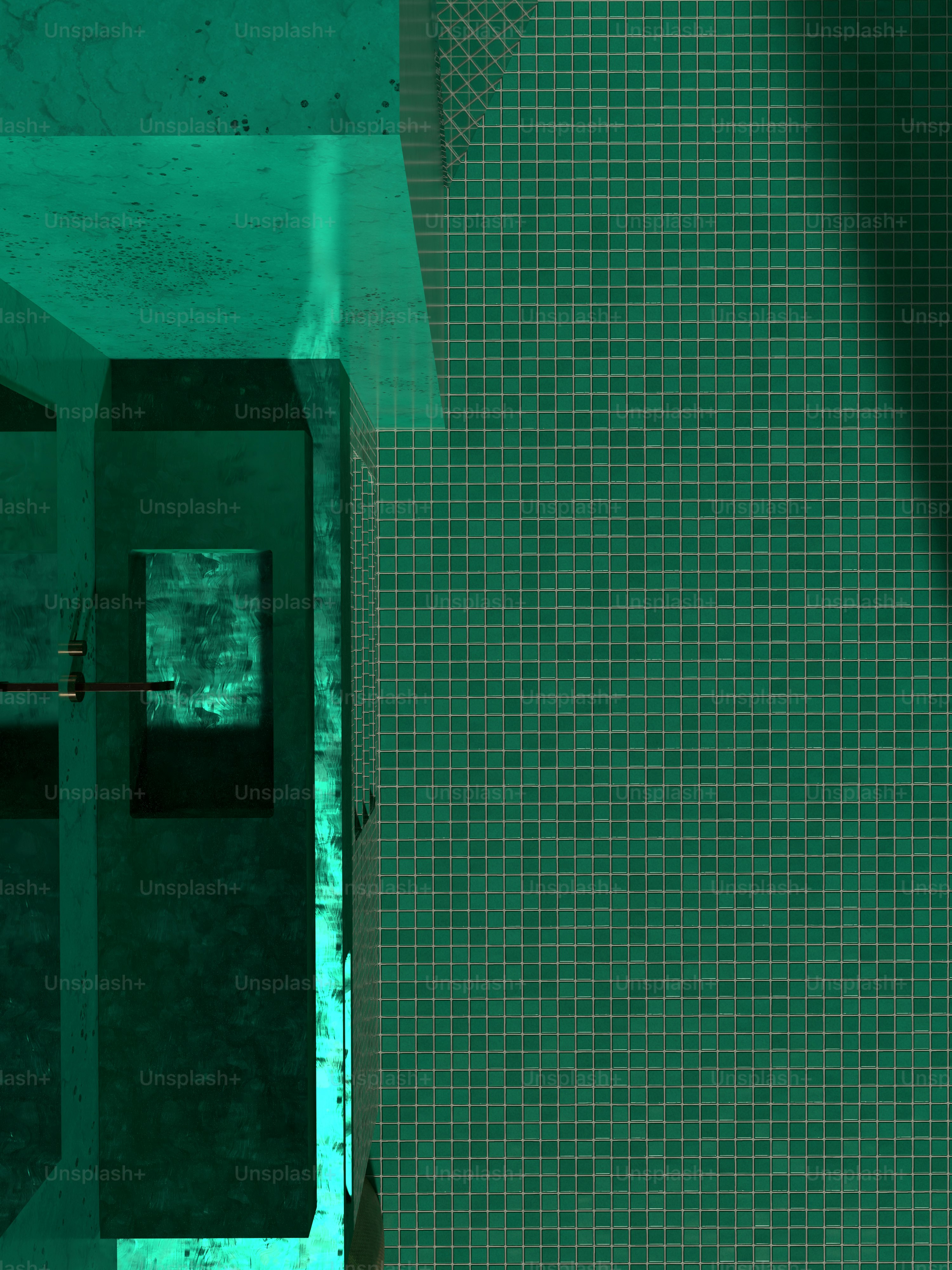 a bathroom with a green tiled wall and floor