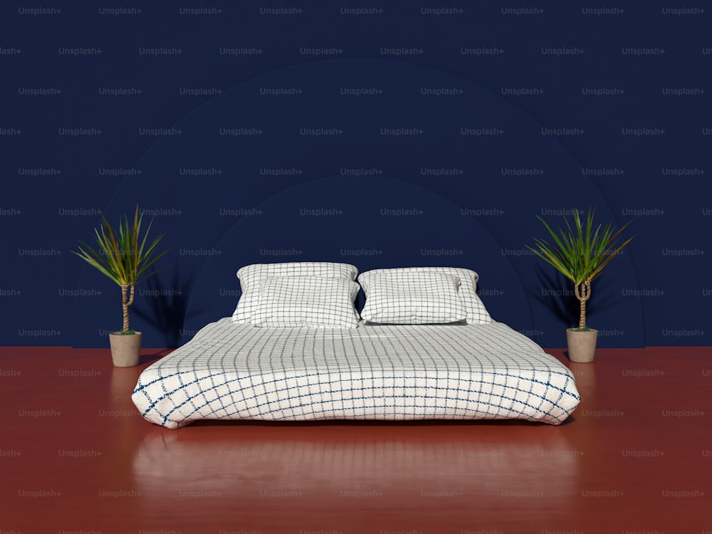 a bed with a checkered comforter and two potted plants