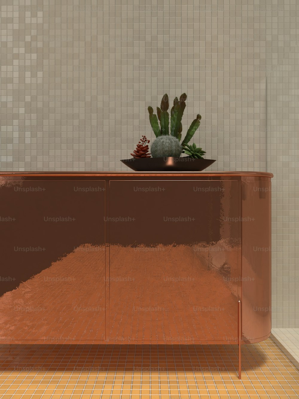 a shiny metal cabinet with a bowl of succulents on top