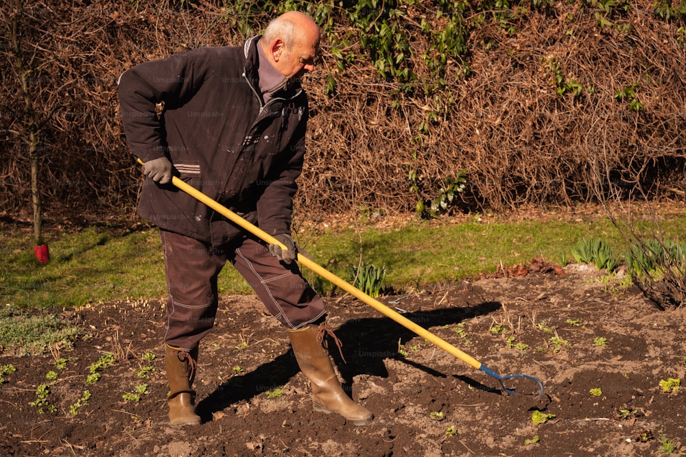 a man is digging in the dirt with a shovel