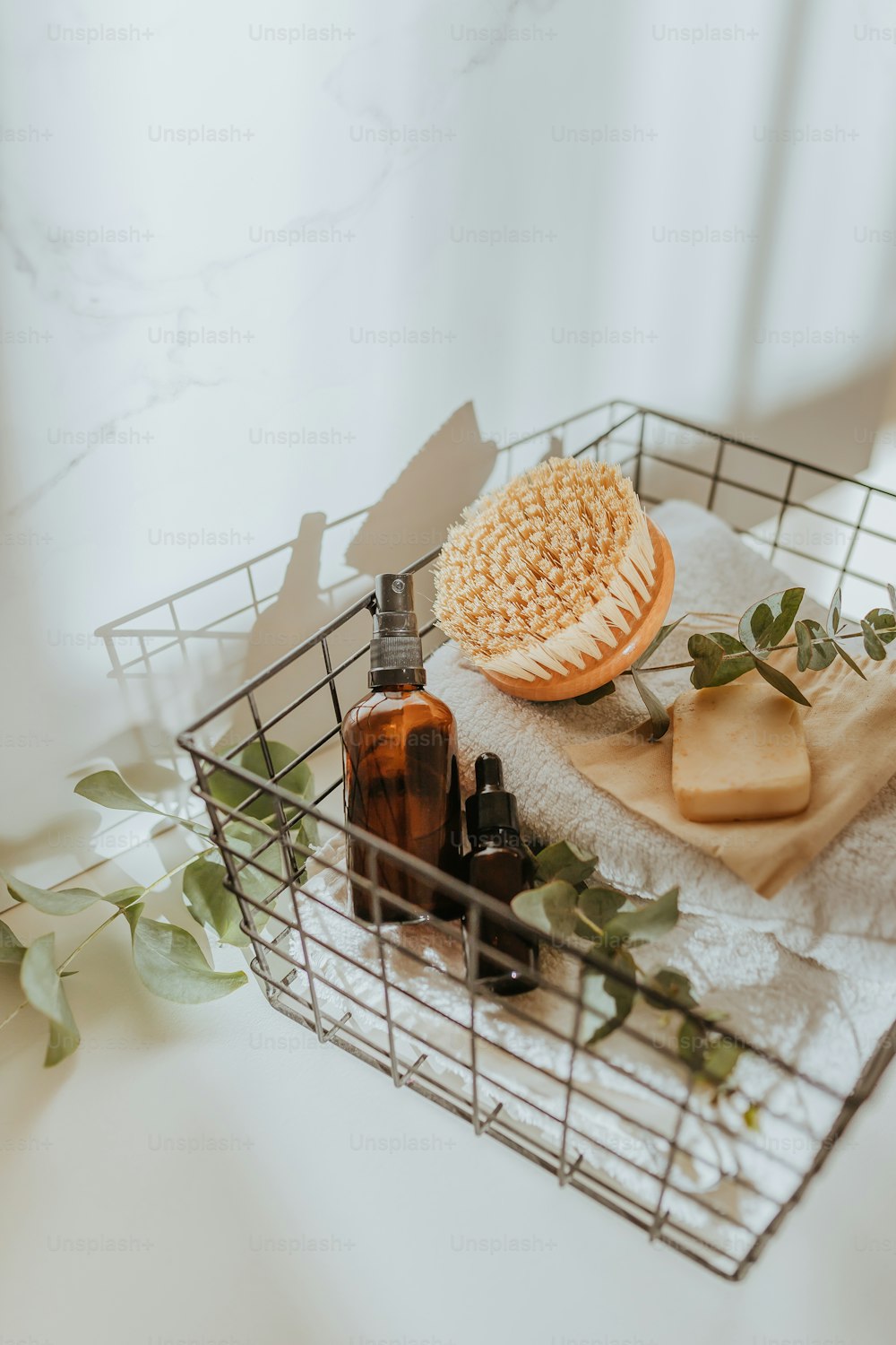 a basket with soap, soap bars, and a bottle of lotion