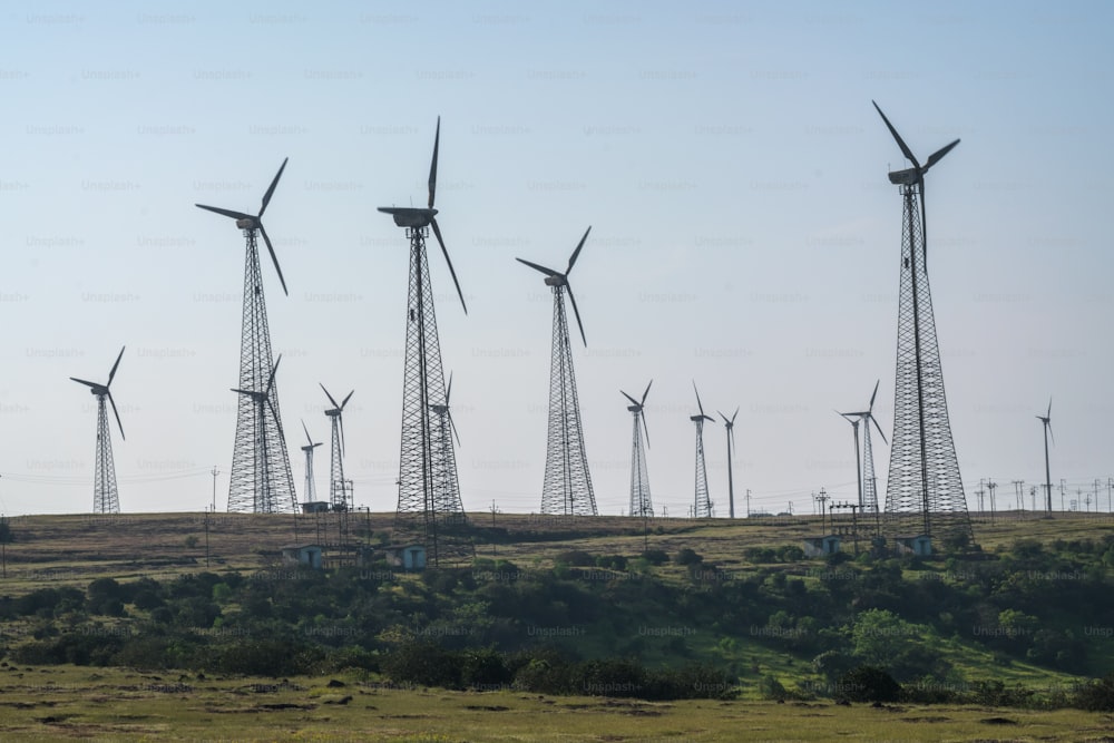 a row of wind turbines on a hill