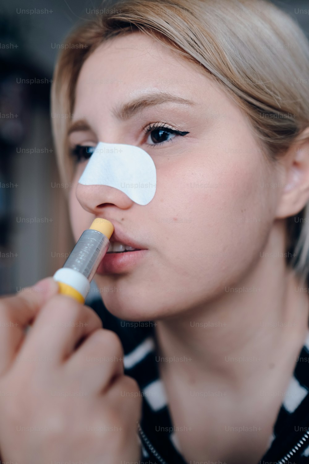 a woman with a nose patch on her nose