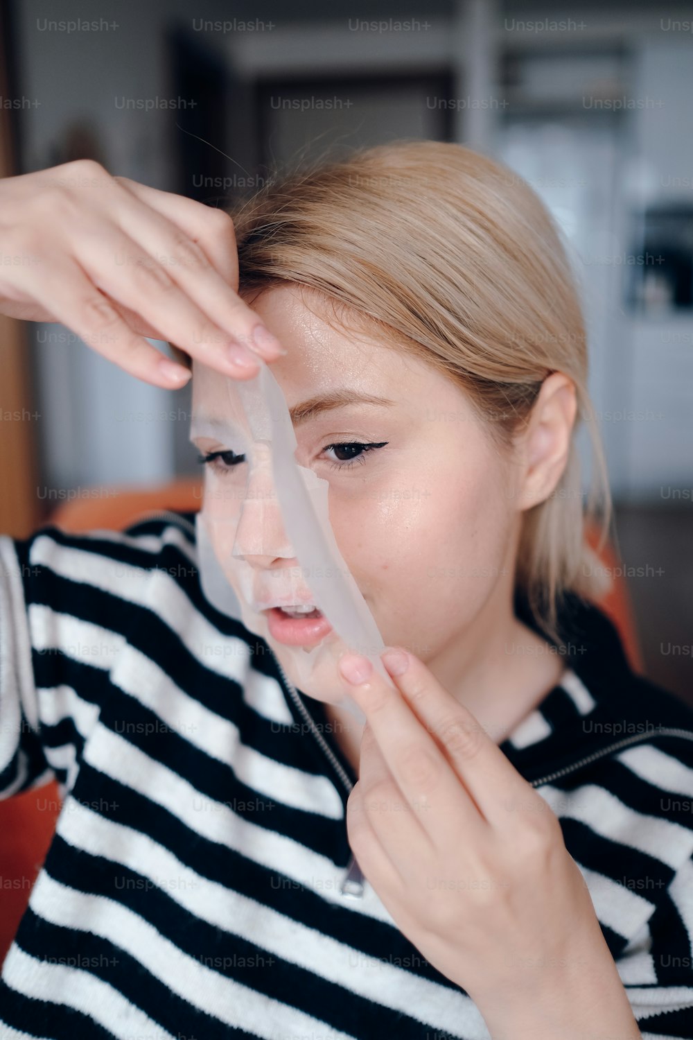 a woman is holding a piece of plastic in her hand