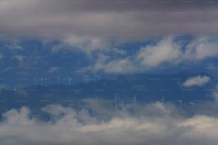 a group of wind mills on a cloudy day