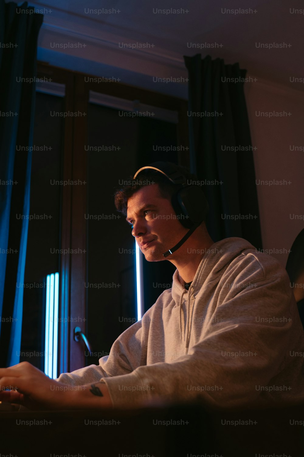a man wearing a headset and using a laptop