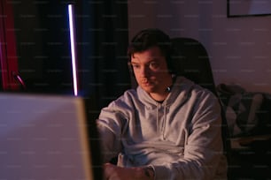 a man sitting in front of a laptop computer