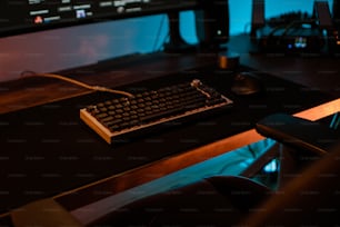 a computer keyboard sitting on top of a wooden desk