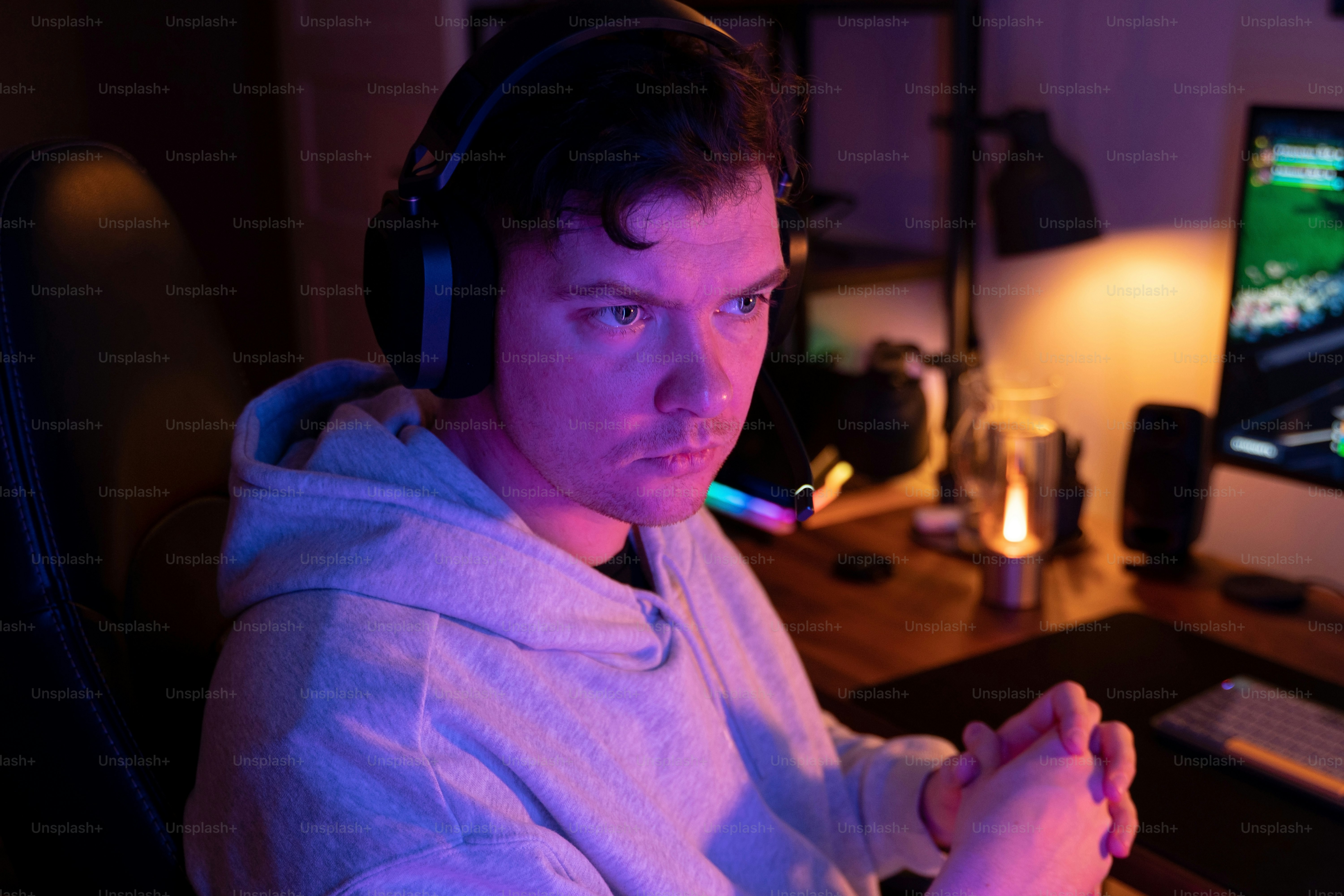 a man wearing headphones sitting in front of a computer