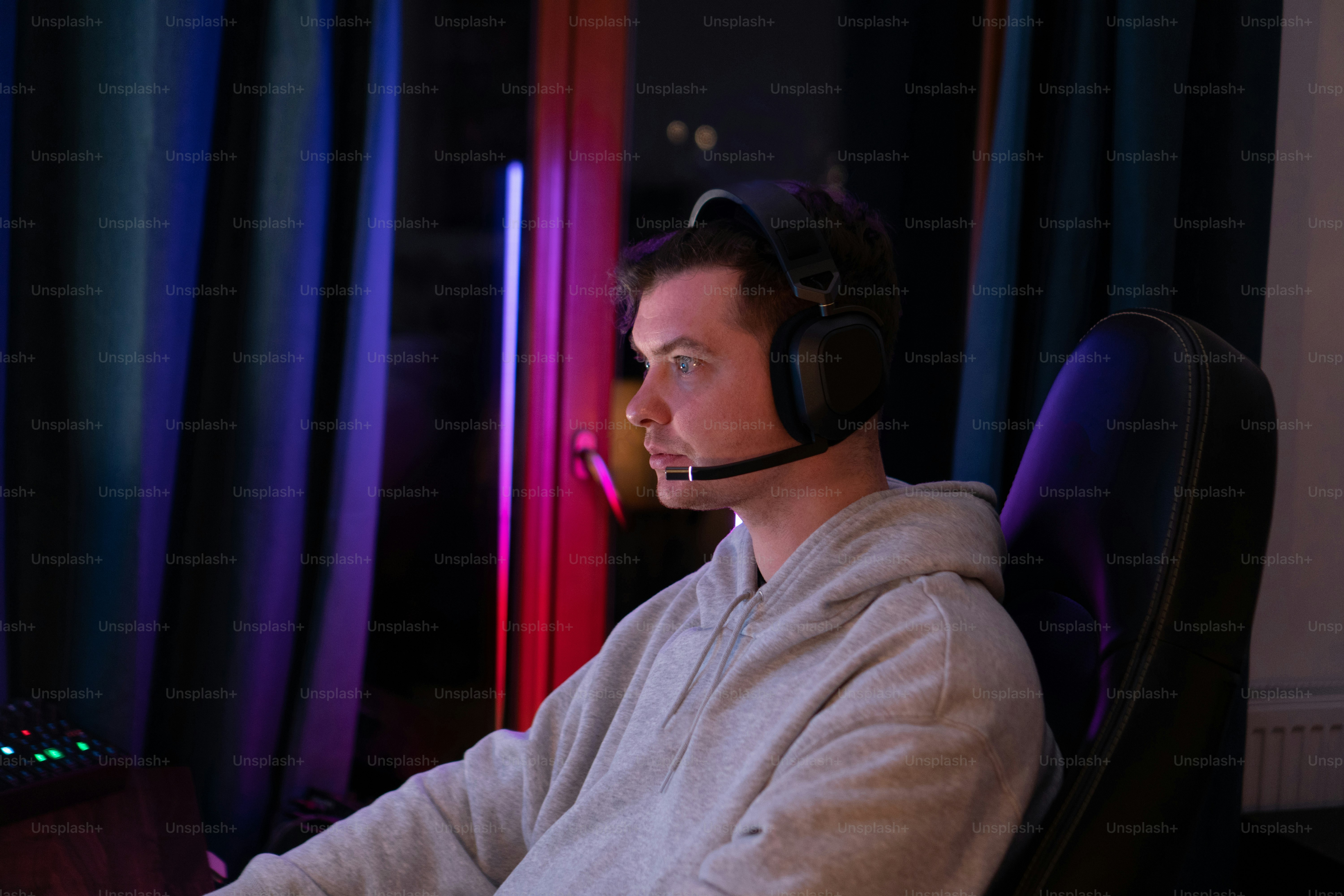 a man wearing a headset sitting in front of a computer
