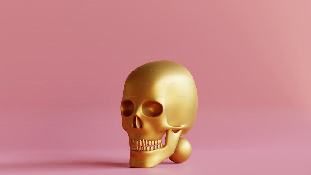 a gold skull on a pink background