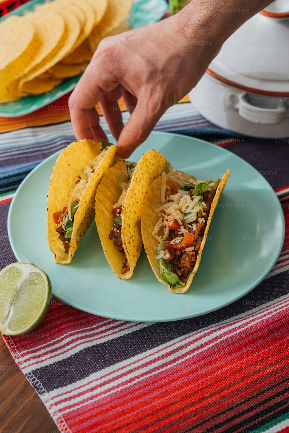 a plate with two tacos and a lime on it