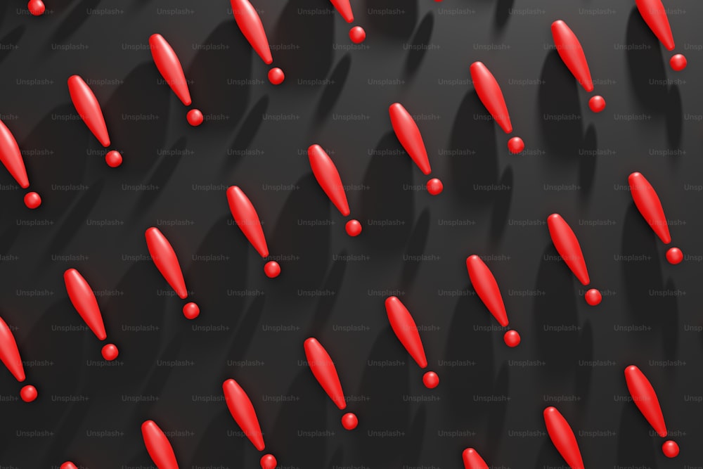 Un mucchio di oggetti rossi che si trovano su una superficie nera