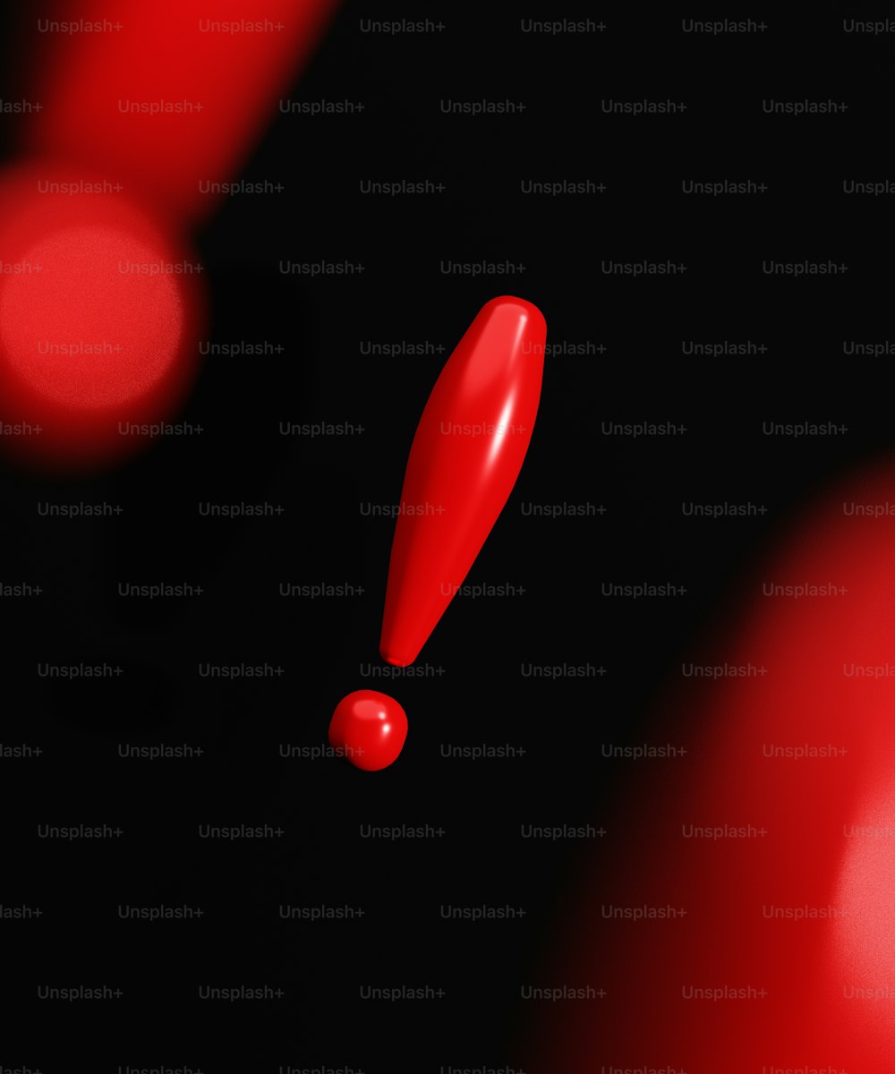 a close up of a red object on a black background