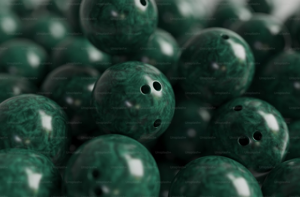 a pile of green bowling balls with holes in them