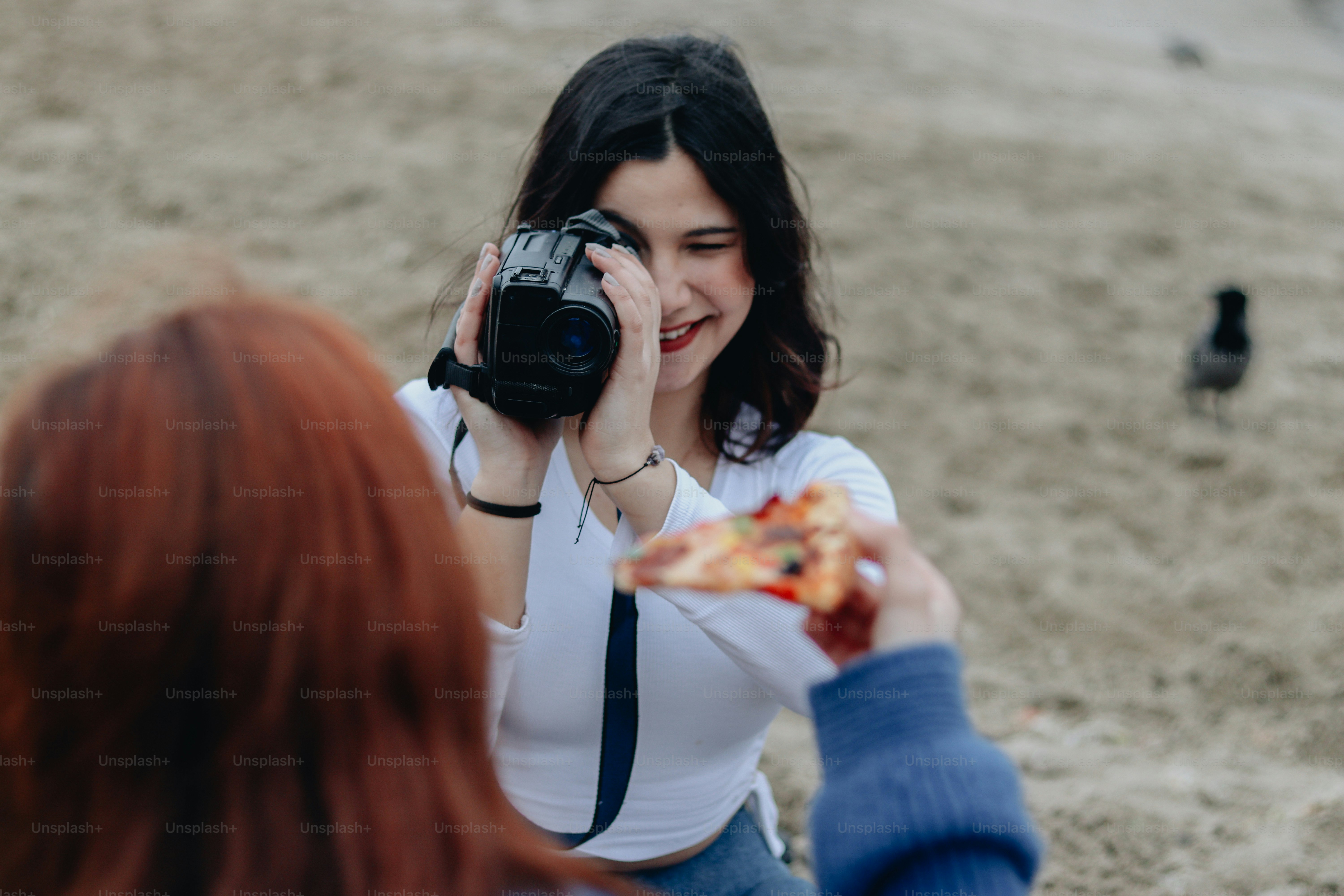 a woman taking a picture of a bird with a camera