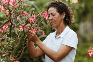 a woman in a white shirt and some pink flowers