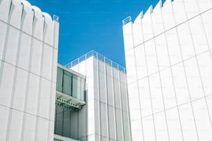 two tall white buildings next to each other