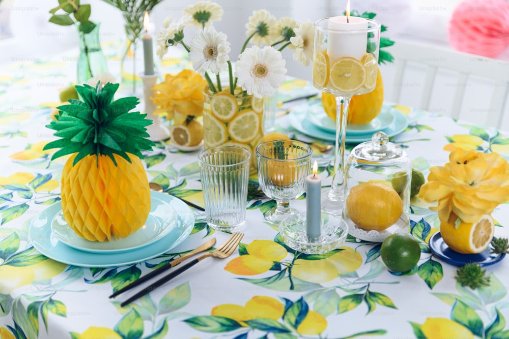 a table topped with plates and glasses filled with fruit