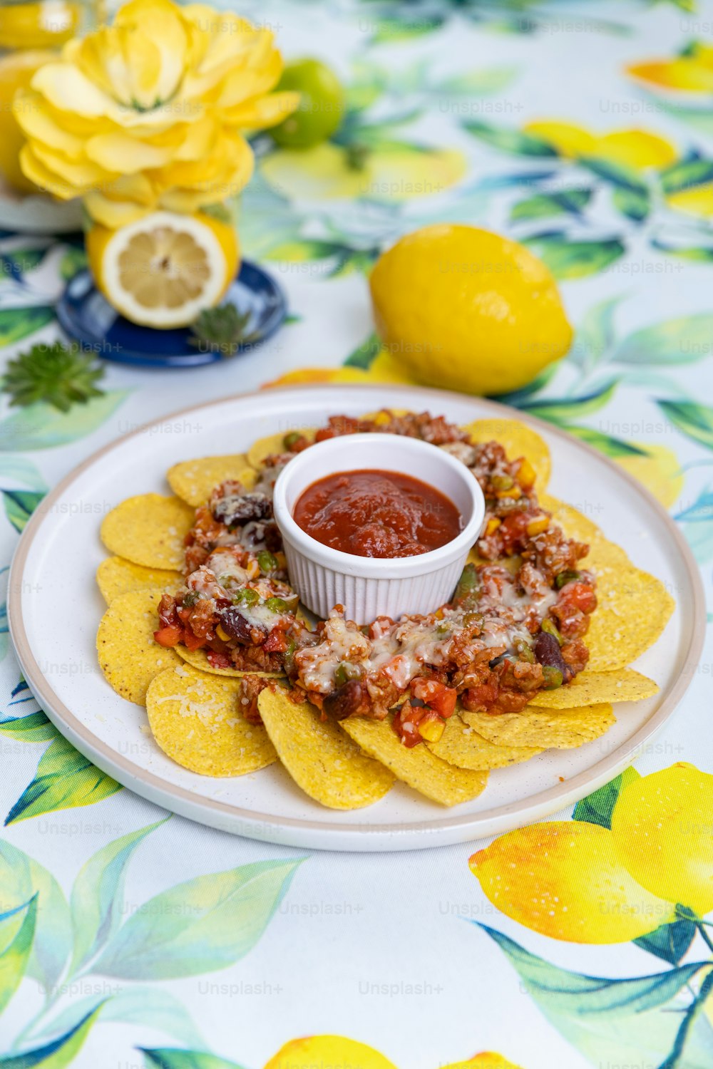 a plate topped with tortilla chips and salsa