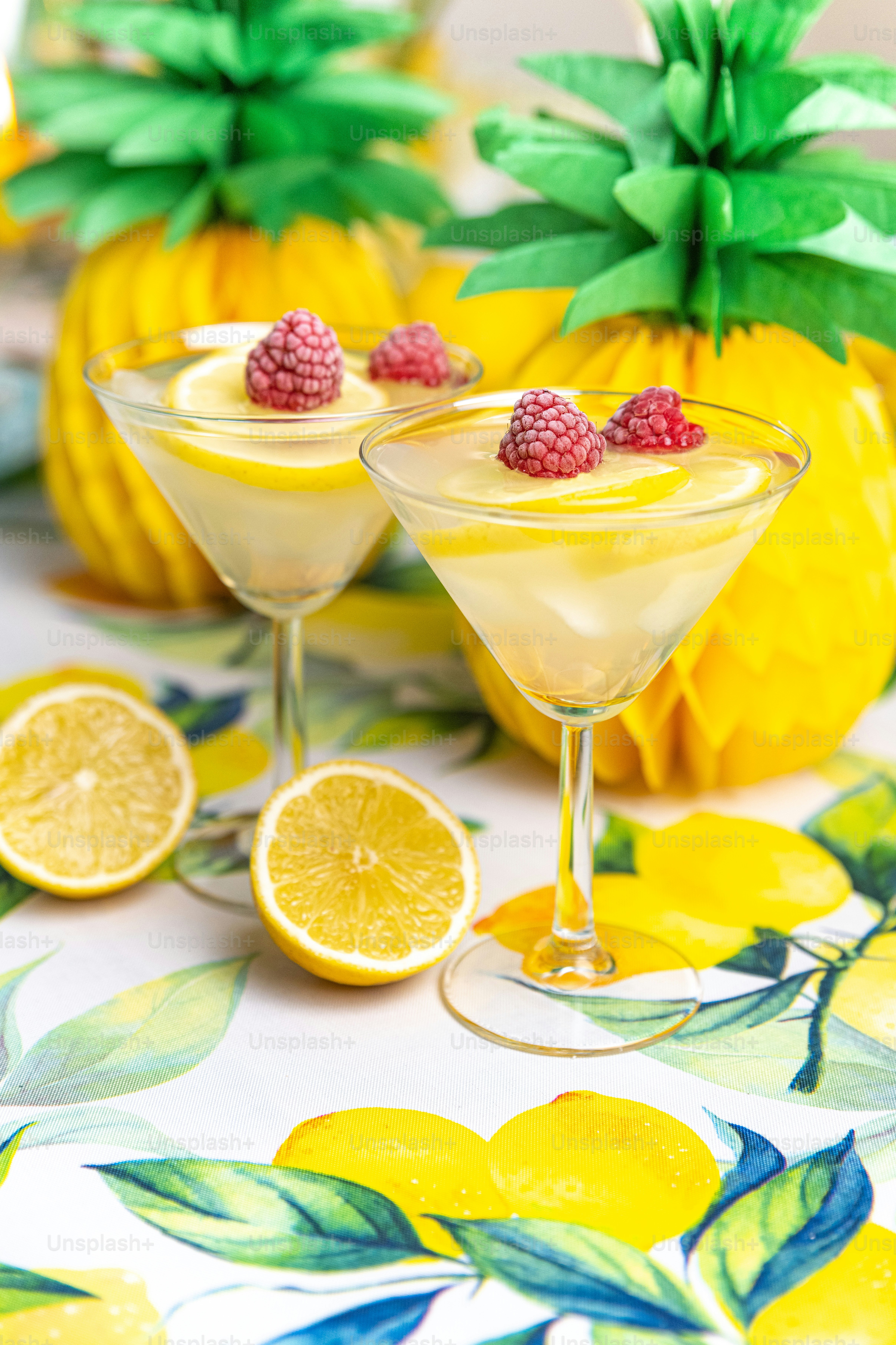 a table topped with two glasses filled with drinks