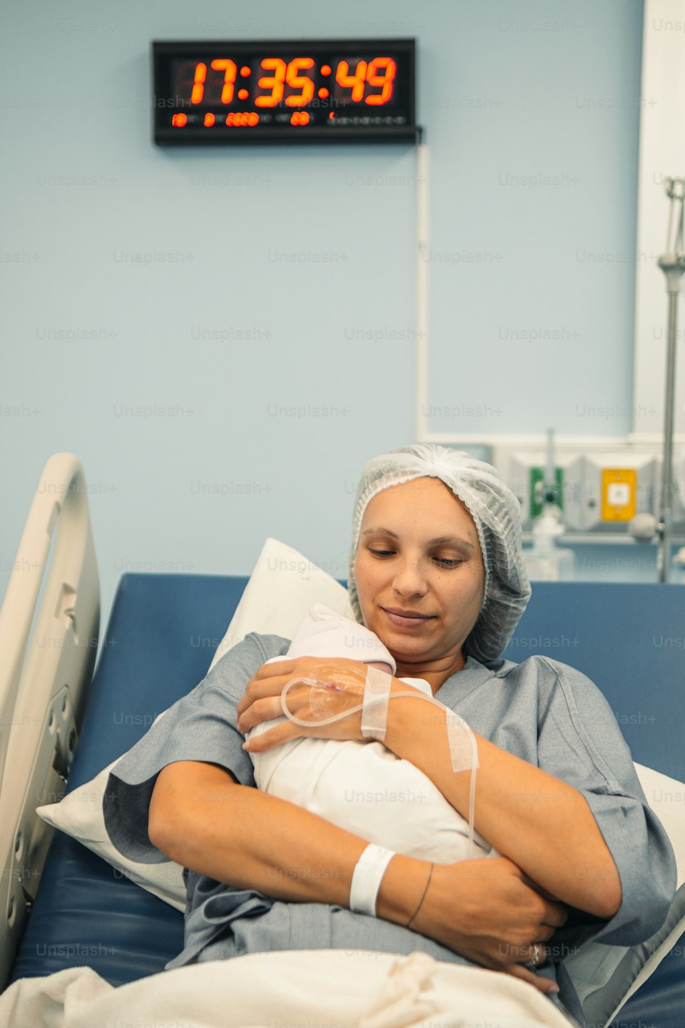 a woman in a hospital bed holding a baby