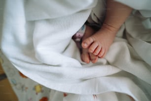 a baby's foot is tucked under a blanket