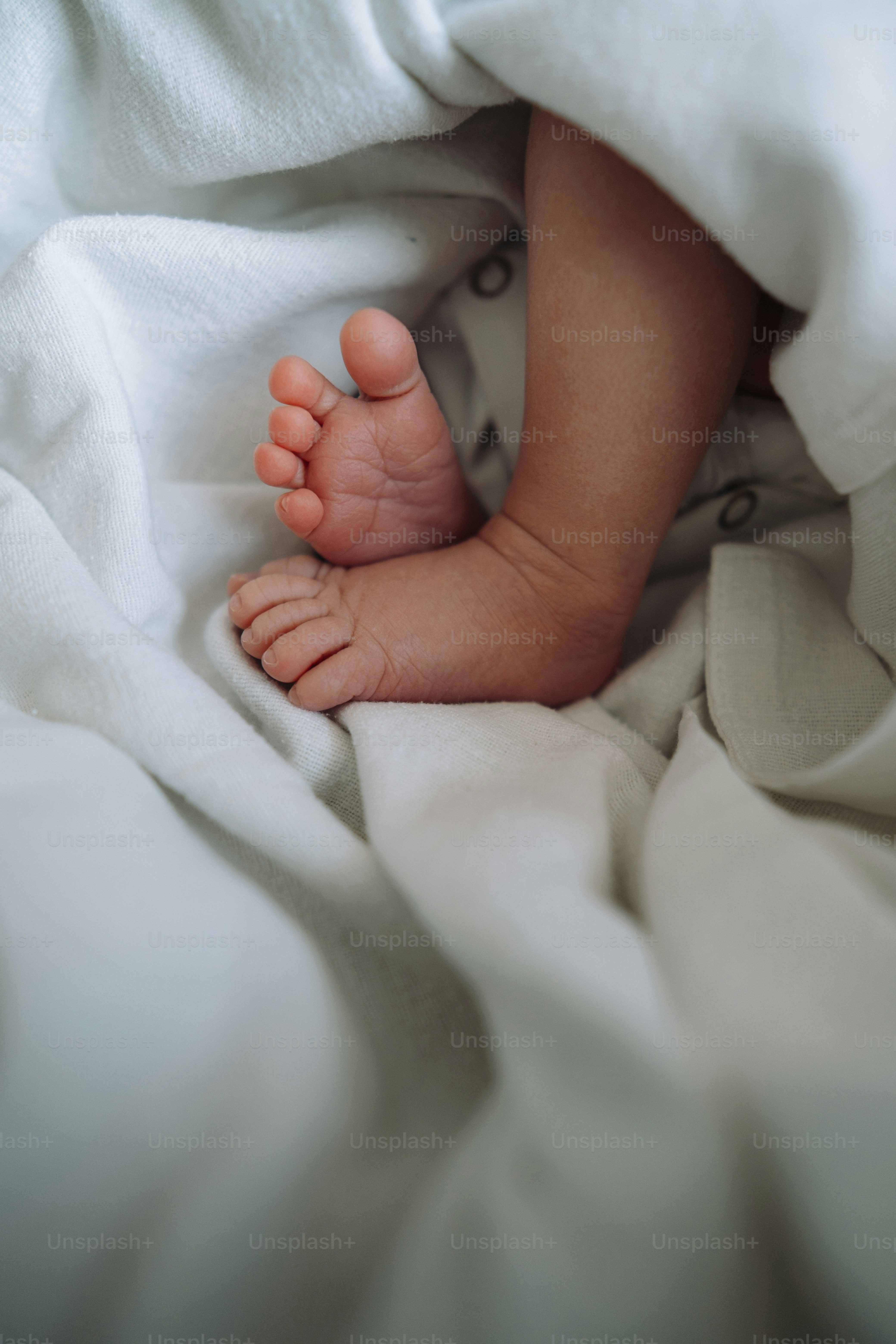 a baby's feet are sticking out of a blanket