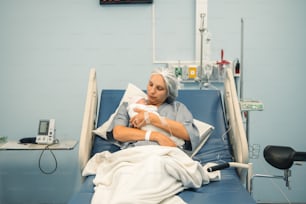 a woman in a hospital bed holding a baby